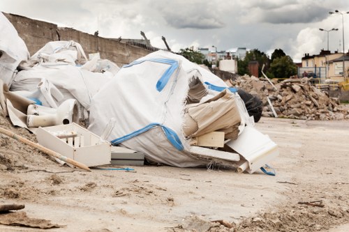Construction workers managing waste on a building site in Eltham